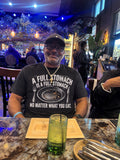 Chad Bibbs wearing the black Full Stomach tee at a restaurant