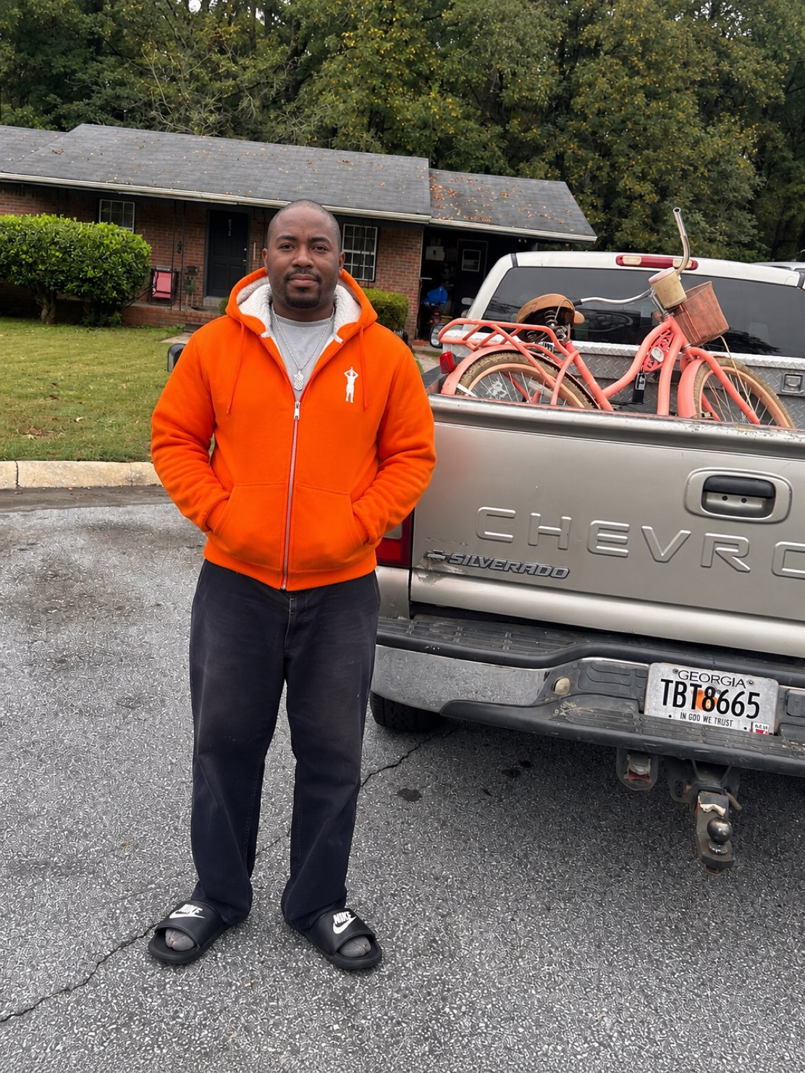 Chad wearing the GHETTO A orange sherpa-lined hoodie